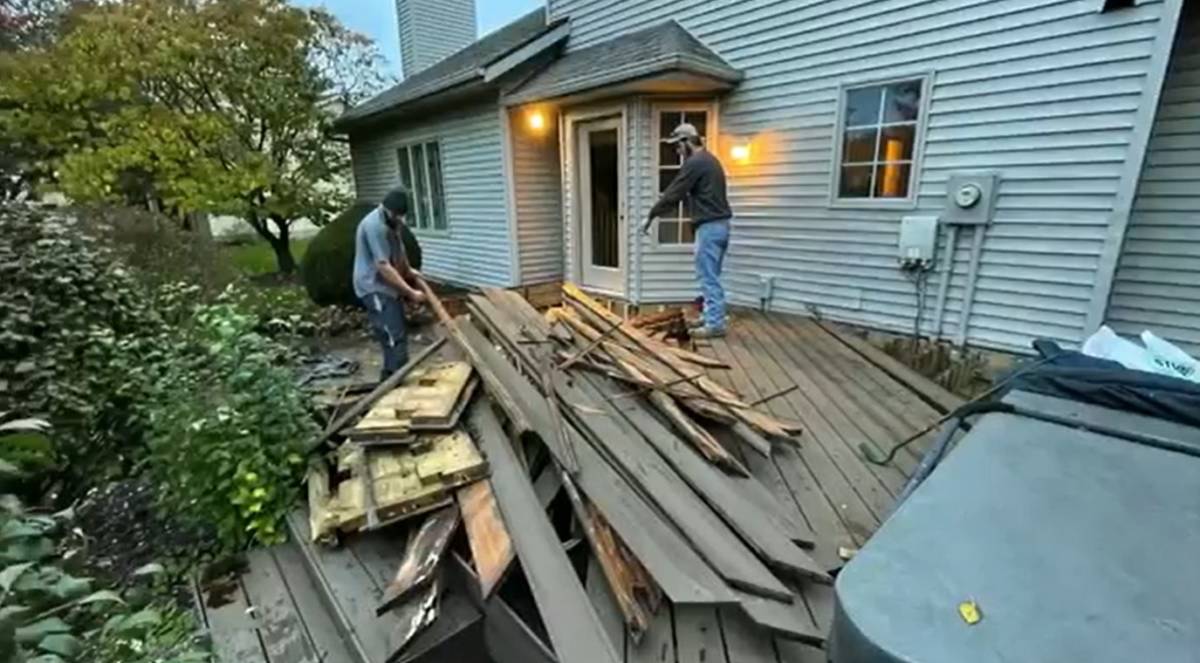 landmark junk removal team demolishing a deck